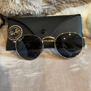 Raybans round polarized gold with black lens. Size 47.